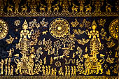 Wat Xieng Thong temple in Luang Prabang, Laos. Detail of the  intricate gold stencilling on black lacquer that decorate the walls of the sim.